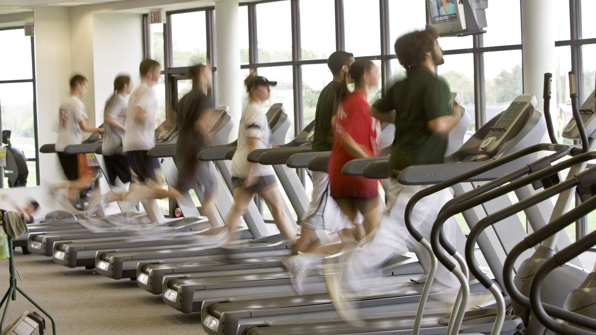 people jogging on treadmills in the activity center